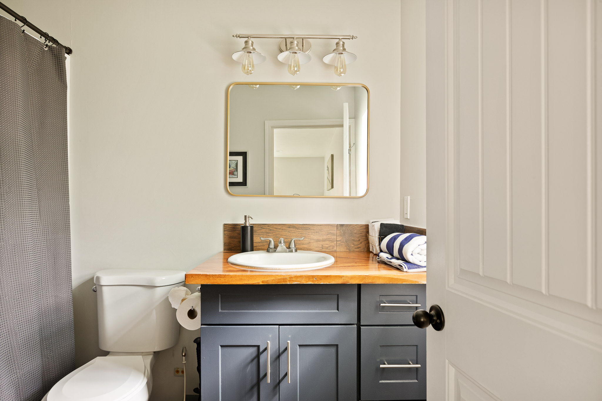 Second angle of the navy vanity bathroom at The Big Bear Cubhouse