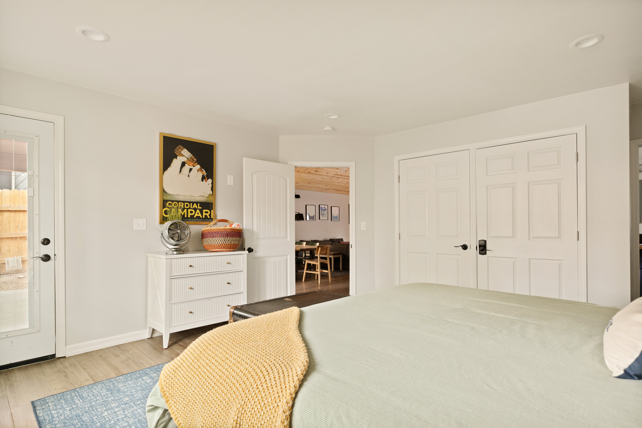 Wide angle of the king bedroom with yellow accents at The Big Bear Cubhouse