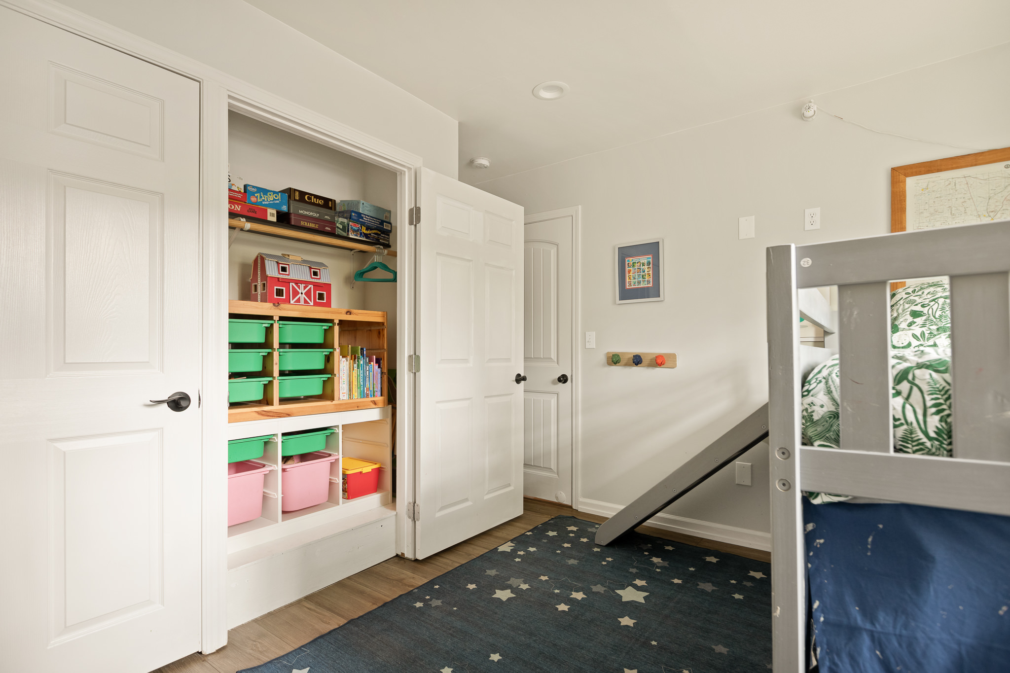 Built-in bookshelf and storage bins in the kids bunk room at The Big Bear Cubhouse